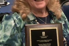 Carell Wingrave and her plaque of the 2025 Frances Wagner Woman of Achievement Award 